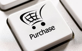 Key on a keyboard that has the image of a shopping trolly on it - under the image is the text 'purchase'.