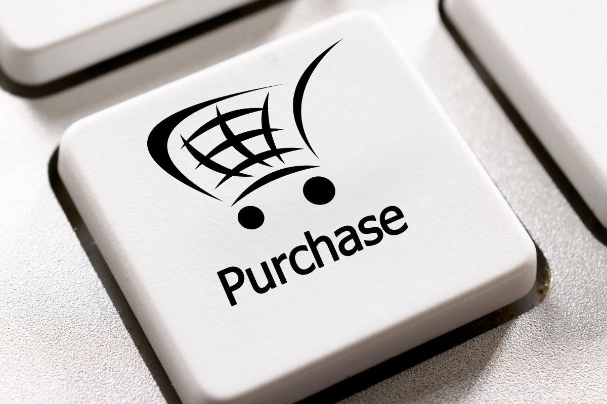 Key on a keyboard that has the image of a shopping trolly on it - under the image is the text 'purchase'.