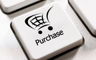 Key on a keyboard that has the image of a shopping trolly on it - under the image is the text 'purchase'.